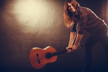 Rock musician destroys his guitar.