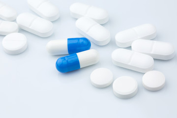 Pharmacy theme.Blue capsules and white antibiotic pills.