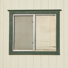 Fototapeta premium old window with plastic window blinds with wood walls.