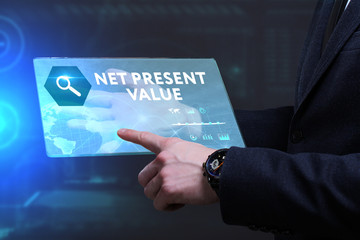 Business, Technology, Internet and network concept. Young businessman working on a virtual screen of the future and sees the inscription: Net present value