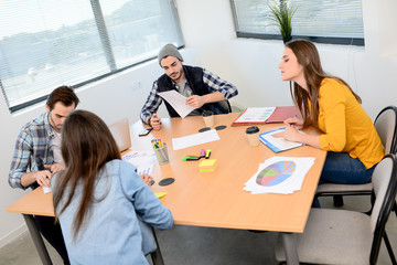 group of young cool hipster business people in casual wear working together in meeting room of a startup company