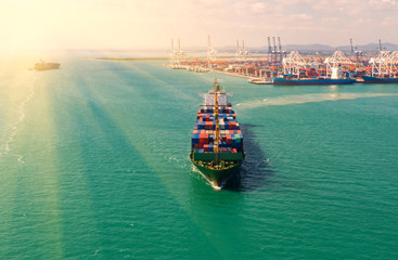 container ship in import export and business logistic.By crane ,Trade Port , Shipping.cargo to...