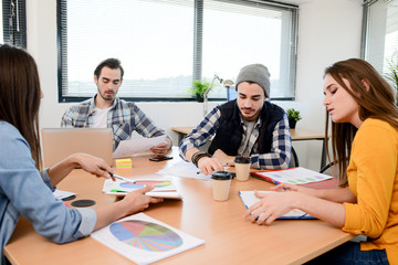 Fototapeta premium group of young cool hipster business people in casual wear working together in meeting room of a startup company