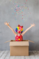 Funny kid clown playing indoor