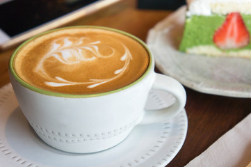 coffee cup and tasty cake relax time book and mobile phone on table in coffee shop