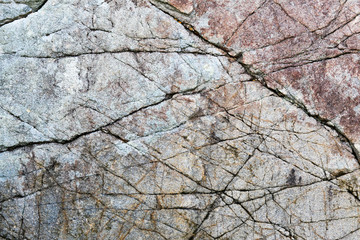 Rock texture and surface background. Cracked and weathered natural stone background.