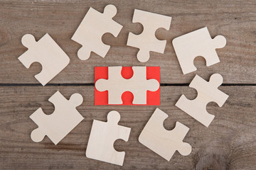 Jigsaw Puzzle Pieces on wooden background