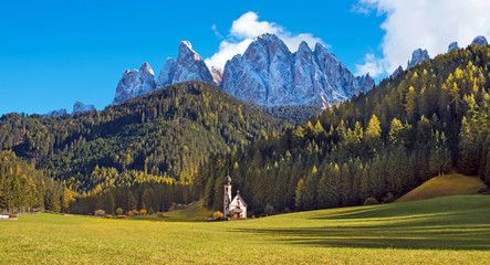 Fototapeta na wymiar Magical landscape with a church in the valley of Santa Magdalena, Italy, Europe, Dolomites