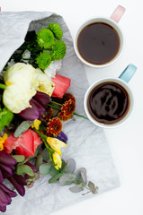 Morning Cup of coffee and a beautiful roses flowers on light background, top view. Cozy Breakfast. Flat lay style.