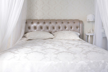 Bed with leather back, pillows and canopy