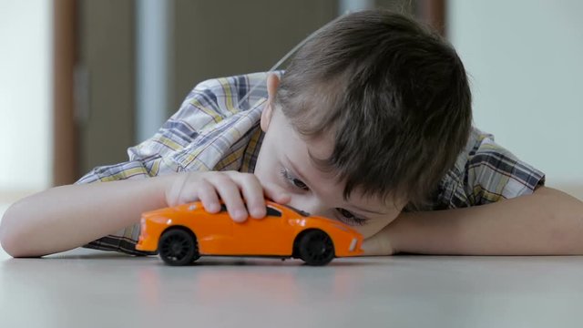 sad little boy lying on the floor at home  at the day time