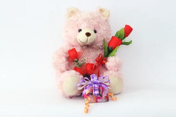Teddy bears, pink and red roses and gift box on a white background.