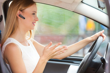 woman driving car with headset