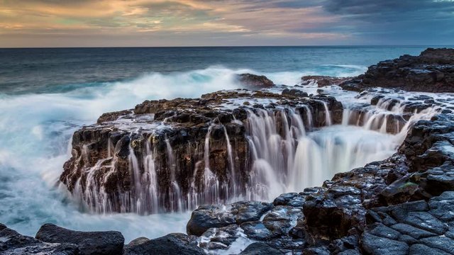 Quee's Bath, Kauai. Giant waves crashes on the shoreline creating beautiful cascades when the waves recedes.
