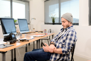 portrait of a young man photographer in casual wear working in creative business startup company office