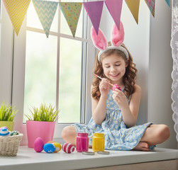 child painting eggs