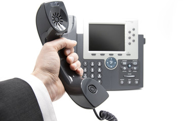 Businessman is picking up the phone receiver