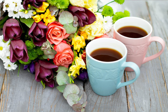 Morning Cup of coffee and a beautiful roses flowers on light background, top view. Cozy Breakfast. Flat lay style.