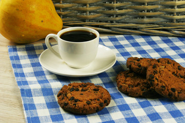Coffee cup with oatmeal cookie chocolate on wooden background