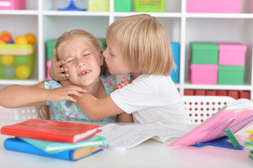 Girl and boy doing lessons