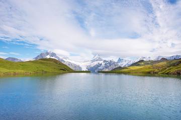 A magical landscape with a lake in the mountains in the Swiss Alps, Europe. Wetterhorn, Schreckhorn, Finsteraarhorn et Bachsee. ( relaxation, harmony, anti-stress - concept).