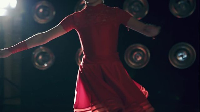 Young ballroom dancer girl in red formal costumes dancing.