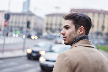 Beautiful young man posing in an urban context