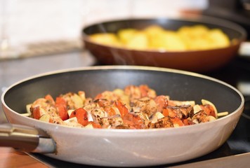 Chicken skewer with vegetables. Frying in a pan.