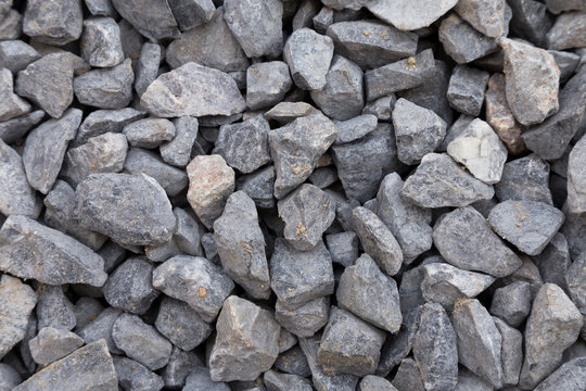 close up of gray crushed rock, stone raw material for construction industry. background and texture.