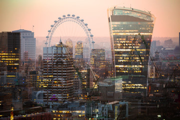 City of London at night. Multiple exposure image includes Walkie-Talkie building, City of London financial aria, London eye at sunset