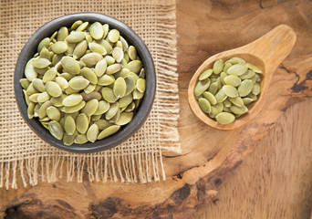 Pumpkin seeds on the wooden background