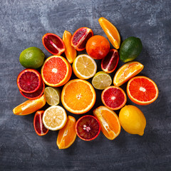 Different Citrus Fruit on a Grey Background .Mixed Colorful Tropical Background.Food or Healthy diet concept.Vegetarian.Copy space for Text. selective focus.