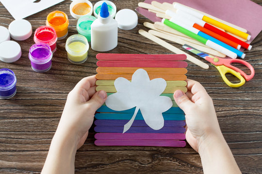 Children odd job gift for St. Patrick's Day clover on a rainbow, a craft of of wooden sticks. Hand-made. Children's Art Project, needlework, crafts for children.