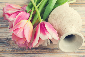 Pink and yellow tulips and vase