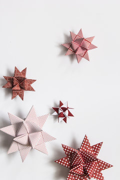 Red and white moravian stars (German christmas ornaments made from paper) on white background
