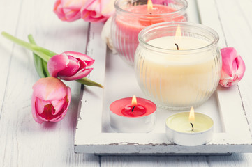Yellow and pink aroma candles with tulips