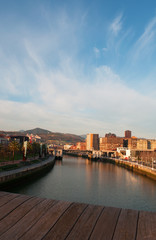 Spagna, 28/01/2017: lo skyline di Bilbao subito dopo l'alba visto dal ponte di legno Pedro Arrupe