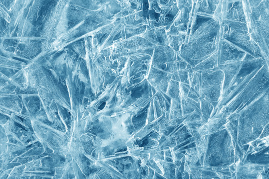 ice background texture. ice with different shapes and cracks. Seasonal frozen water backdrop. Pond surface.