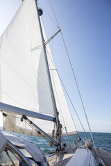 Fototapeta na wymiar Yacht Sailing On Sea Against Blue Sky