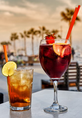 Cocktails on beach bar with palm trees background; focus on drinks