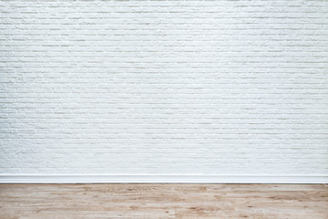 White brick wall and plank wood floor.