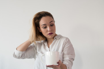 Woman drinking coffee in the morning at modern kitchen