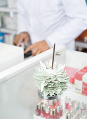 Tags In Holder With Chemist Working In Background