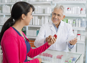 Fototapeta premium Senior Chemist And Woman With Prescription In Pharmacy