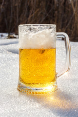 Glass of beer in the snow.