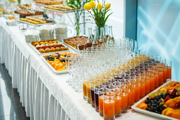 Catering. Cakes and pies on white tables