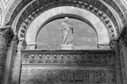 Beautiful bas-relief above the entrance to the Baptistery of San Giovanni in Pisa, Italy. Monochrome image