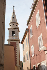 Belfry of the Christian church in the gap between the houses of the old city.