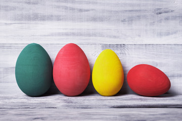 Painted eggs over wooden background