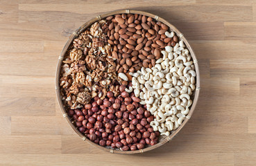 Different nuts in old wooden dish